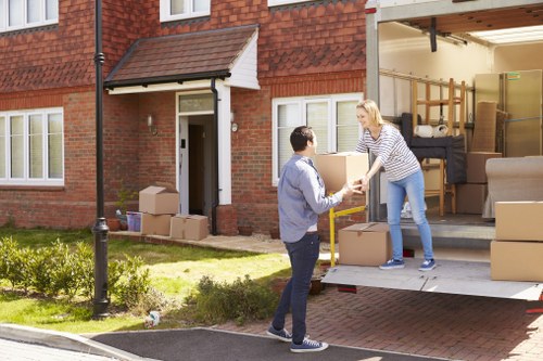 Flat removals team handling boxes outside a Fulham apartment building