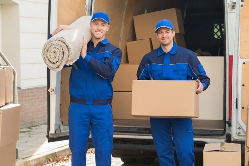 Removal crew loading boxes while following safety rules