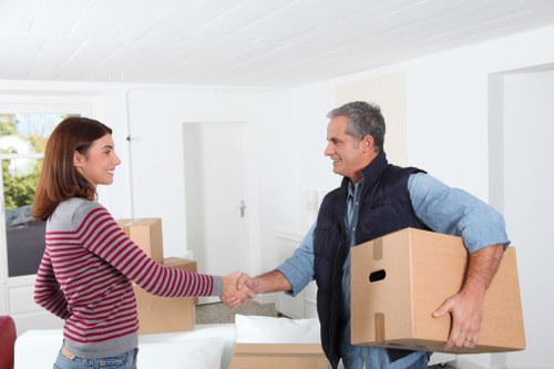 Move team carrying boxes from a Fulham flat with narrow access