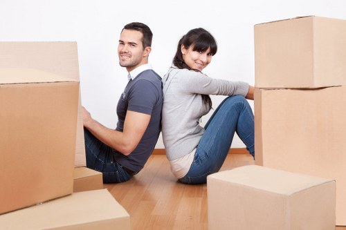 Professional movers handling items in a Fulham apartment building